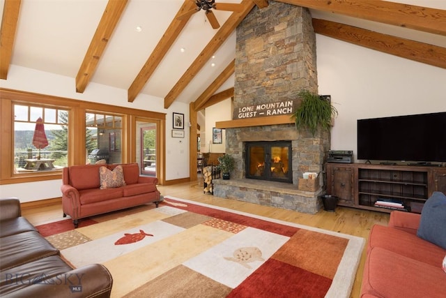 526 Chief Joseph, Big Sky, MT 59716 - living room featuring a stone fireplace, wood finished floors, beam ceiling, ceiling fan, and recessed lighting