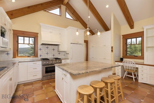 526 Chief Joseph, Big Sky, MT 59716 - kitchen featuring white refrigerator, high end stove, beam ceiling, white cabinets, and backsplash