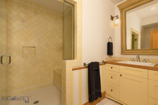 526 Chief Joseph, Big Sky, MT 59716 - full bath featuring tile patterned flooring, tiled shower, vanity, and wallpapered walls