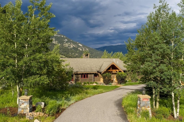 526 Chief Joseph, Big Sky, MT 59716 - view of front of home with a mountain view and a chimney