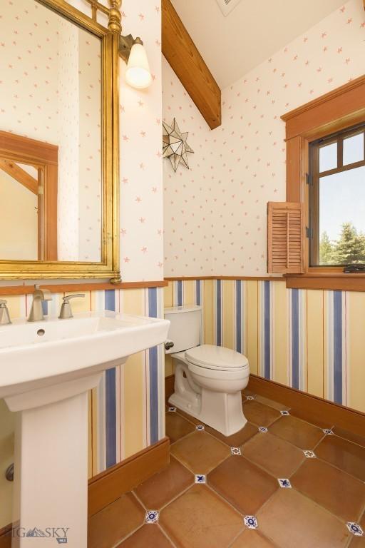 526 Chief Joseph, Big Sky, MT 59716 - half bath featuring wallpapered walls and beam ceiling
