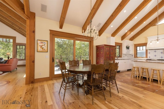 526 Chief Joseph, Big Sky, MT 59716 - dining space with beam ceiling, high vaulted ceiling, recessed lighting, light wood-type flooring, and a chandelier