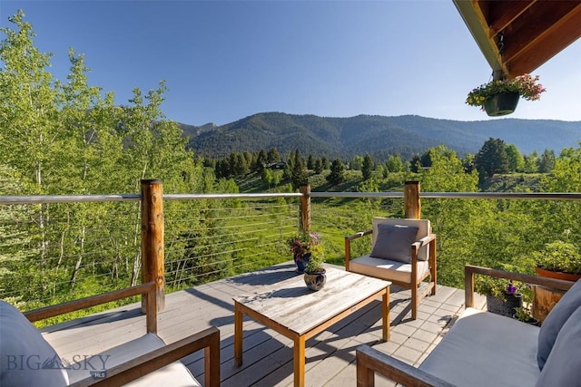 526 Chief Joseph, Big Sky, MT 59716 - wooden terrace featuring a mountain view and a view of trees