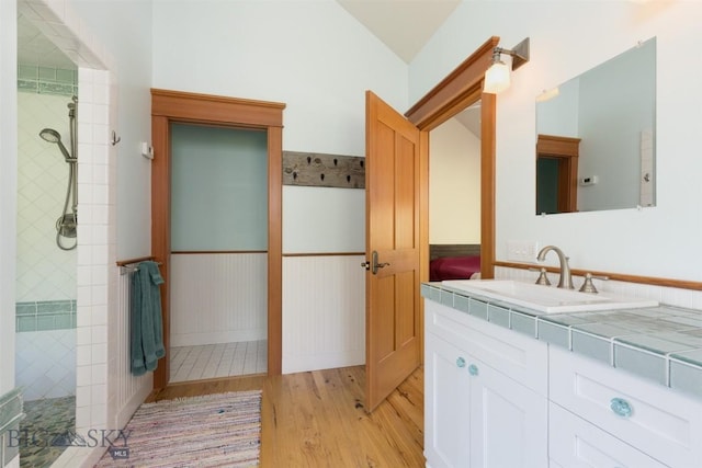526 Chief Joseph, Big Sky, MT 59716 - full bath with wood finished floors, vanity, tiled shower, and wainscoting