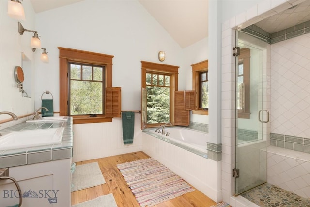 526 Chief Joseph, Big Sky, MT 59716 - bathroom with lofted ceiling, a shower stall, wood finished floors, a garden tub, and double vanity