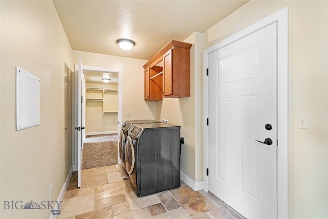 1705 Ingomar Blvd, Belgrade, MT 59714 - laundry area with cabinet space, washing machine and clothes dryer, and stone tile flooring