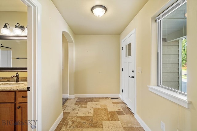 1705 Ingomar Blvd, Belgrade, MT 59714 - hallway with stone tile floors and arched walkways