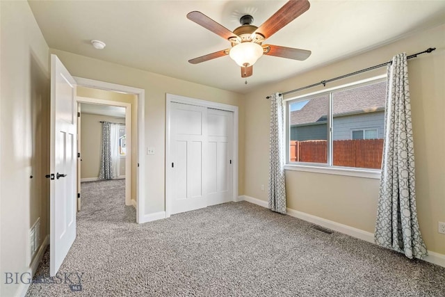 1705 Ingomar Blvd, Belgrade, MT 59714 - unfurnished bedroom featuring carpet, a closet, and ceiling fan