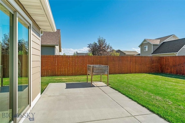 1705 Ingomar Blvd, Belgrade, MT 59714 - fenced backyard with a patio area