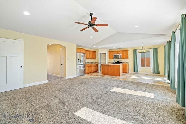 1705 Ingomar Blvd, Belgrade, MT 59714 - unfurnished living room with lofted ceiling, arched walkways, a ceiling fan, recessed lighting, and light colored carpet