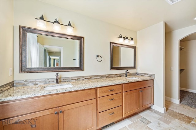 1705 Ingomar Blvd, Belgrade, MT 59714 - bathroom featuring double vanity and stone finish flooring