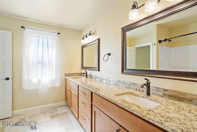 1705 Ingomar Blvd, Belgrade, MT 59714 - bathroom featuring baseboards and double vanity