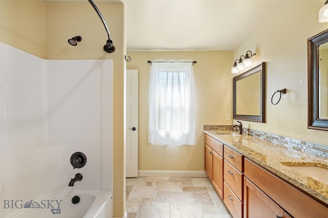 1705 Ingomar Blvd, Belgrade, MT 59714 - bathroom featuring double vanity, shower / bath combination, and stone tile flooring