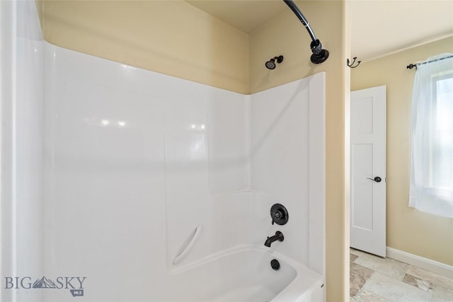1705 Ingomar Blvd, Belgrade, MT 59714 - full bath featuring shower / tub combination and stone finish floors