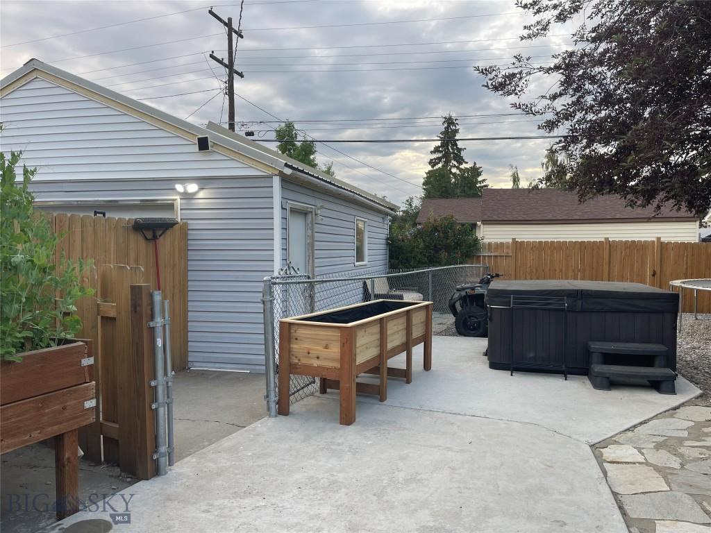 2625 St Ann St, Butte, MT 59701 - fenced backyard with a hot tub and a patio