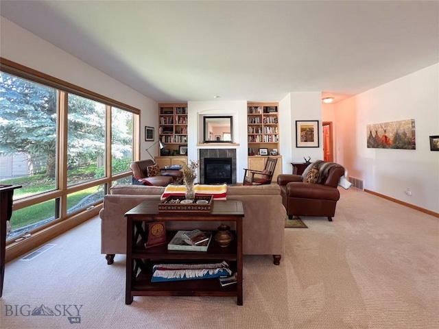 1031 Boylan, Bozeman, MT 59715 - carpeted living room featuring a tile fireplace, healthy amount of natural light, and built in features