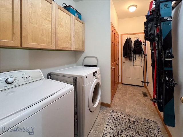 1031 Boylan, Bozeman, MT 59715 - laundry room with cabinet space, independent washer and dryer, and light tile patterned floors