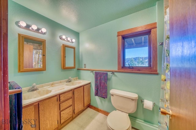 8799 Huffman Ln, Bozeman, MT 59715 - bathroom with double vanity, a textured ceiling, and baseboard heating