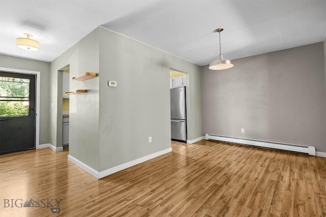2020 S Rouse Unit 7, Bozeman, MT 59715 - unfurnished room featuring baseboard heating and light wood-style floors
