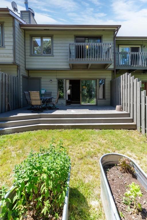 2020 S Rouse Unit 7, Bozeman, MT 59715 - back of house featuring a balcony, a wooden deck, and a chimney