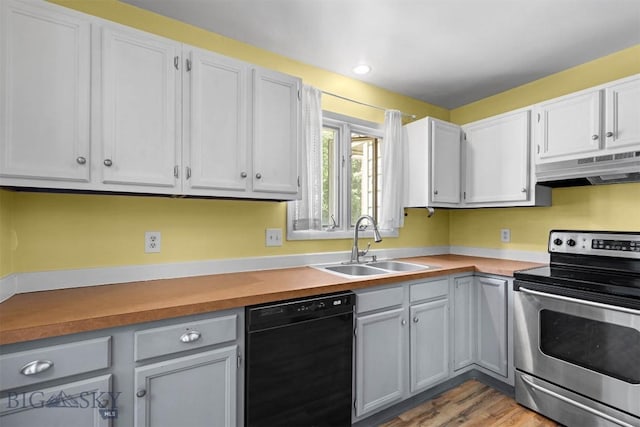 2020 S Rouse Unit 7, Bozeman, MT 59715 - kitchen featuring black dishwasher, electric stove, under cabinet range hood, light wood-style flooring, and light countertops