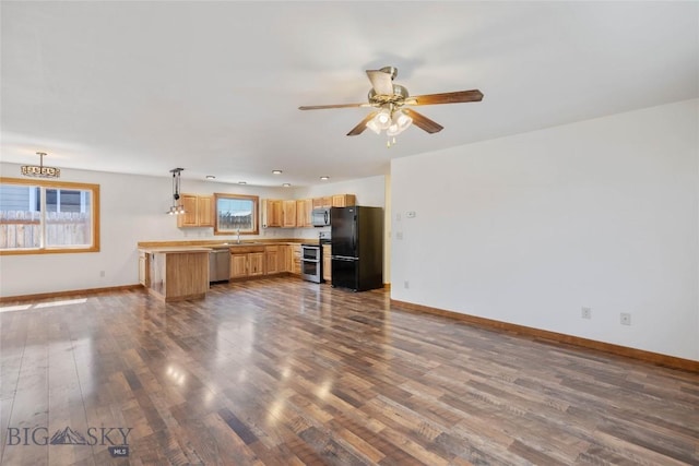 616 W Adams St, Three Forks, MT 59752 - unfurnished living room featuring dark wood-style flooring and a ceiling fan