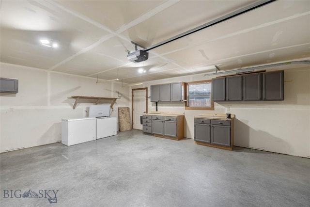 616 W Adams St, Three Forks, MT 59752 - garage featuring a garage door opener and washer and clothes dryer