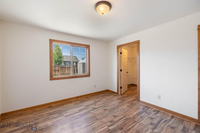 616 W Adams St, Three Forks, MT 59752 - spare room featuring wood finished floors and baseboards