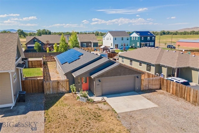 616 W Adams St, Three Forks, MT 59752 - view of front facade with concrete driveway, a residential view, a garage, and solar panels