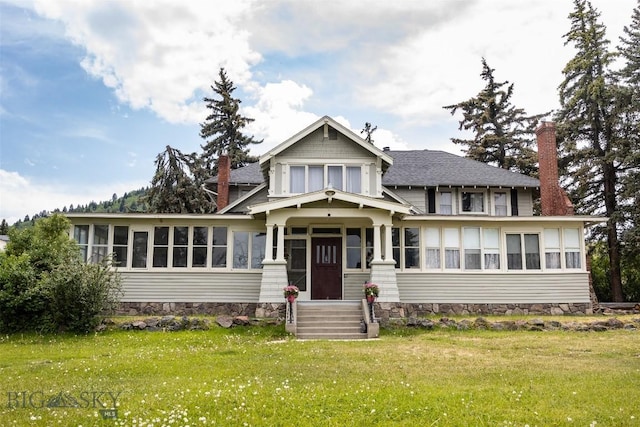 300 Holmes, Butte, MT 59701 - view of front of property with a sunroom, a chimney, a front yard, and a shingled roof