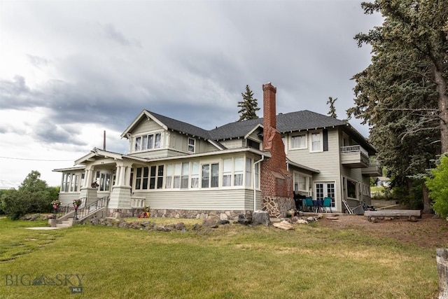 300 Holmes, Butte, MT 59701 - rear view of property featuring a chimney, a lawn, a balcony, and a shingled roof