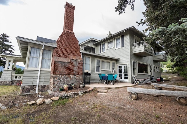 300 Holmes, Butte, MT 59701 - back of property featuring a balcony, french doors, a patio, and a chimney