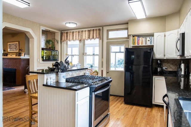 300 Holmes, Butte, MT 59701 - kitchen with stainless steel appliances, a breakfast bar, white cabinets, and decorative backsplash