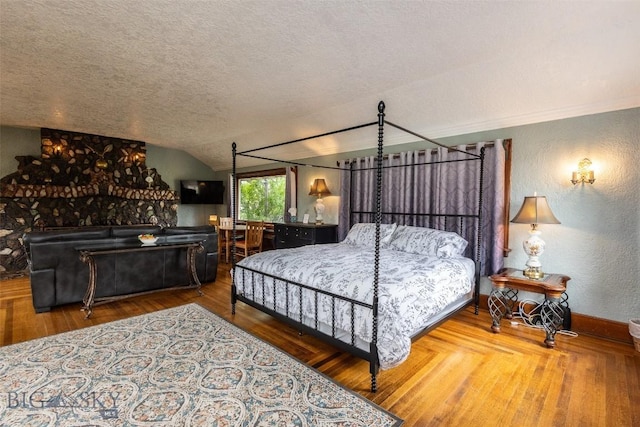 300 Holmes, Butte, MT 59701 - bedroom featuring a textured ceiling, lofted ceiling, a textured wall, and wood finished floors
