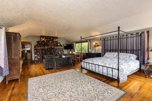 300 Holmes, Butte, MT 59701 - bedroom featuring a textured ceiling, vaulted ceiling, and wood finished floors