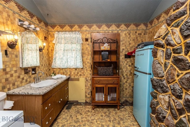 300 Holmes, Butte, MT 59701 - bathroom with vaulted ceiling, vanity, radiator, and tile patterned floors
