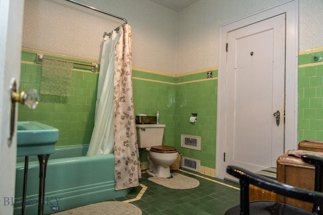 300 Holmes, Butte, MT 59701 - full bath featuring tile walls, shower / tub combo, tile patterned floors, and a wainscoted wall