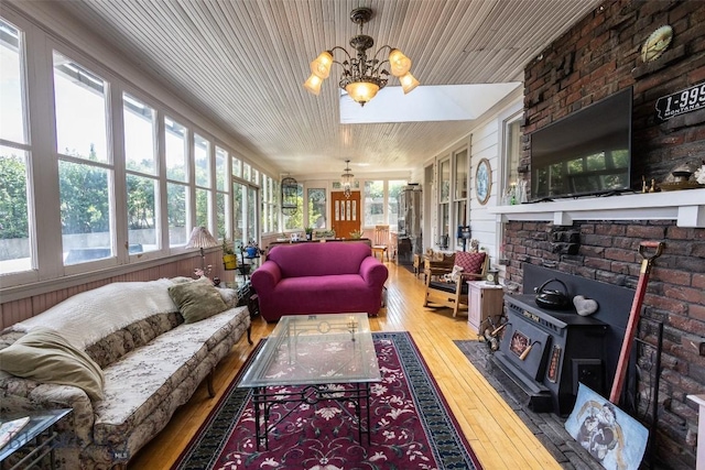 300 Holmes, Butte, MT 59701 - sunroom / solarium featuring a chandelier, hardwood / wood-style flooring, wood ceiling, and a wood stove