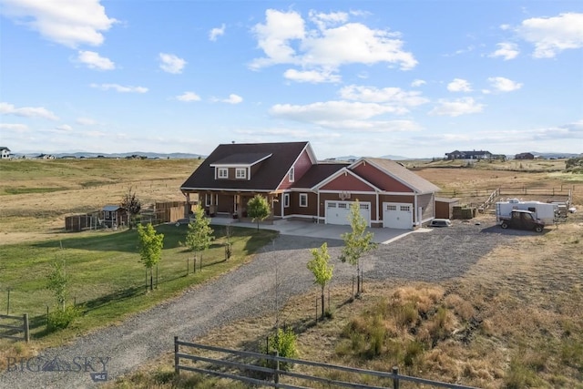 219 Rolling Glen Ranch Loop, Three Forks, MT 59752 - view of front facade with dirt driveway, an attached garage, a porch, and a rural view