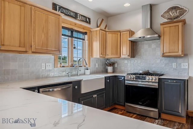 219 Rolling Glen Ranch Loop, Three Forks, MT 59752 - kitchen featuring wall chimney exhaust hood, appliances with stainless steel finishes, dark wood-type flooring, backsplash, and light stone counters