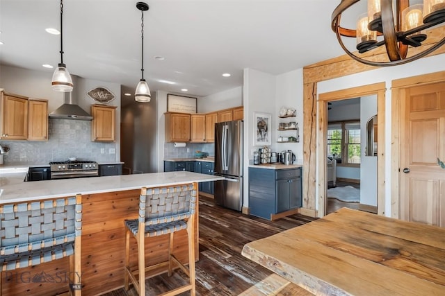 219 Rolling Glen Ranch Loop, Three Forks, MT 59752 - kitchen featuring appliances with stainless steel finishes, light countertops, dark wood-style flooring, tasteful backsplash, and wall chimney range hood