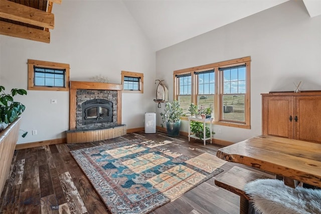 219 Rolling Glen Ranch Loop, Three Forks, MT 59752 - living room featuring high vaulted ceiling, dark wood finished floors, and a stone fireplace