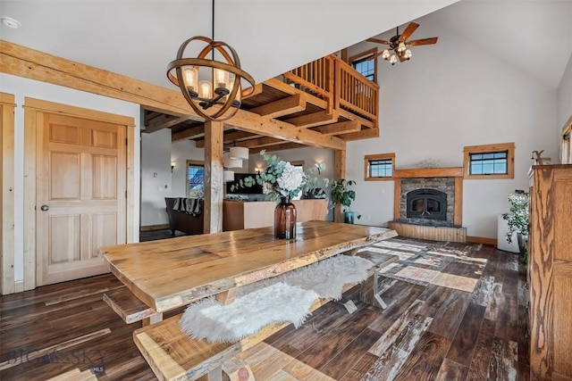 219 Rolling Glen Ranch Loop, Three Forks, MT 59752 - dining room with a chandelier, a ceiling fan, high vaulted ceiling, wood finished floors, and a glass covered fireplace