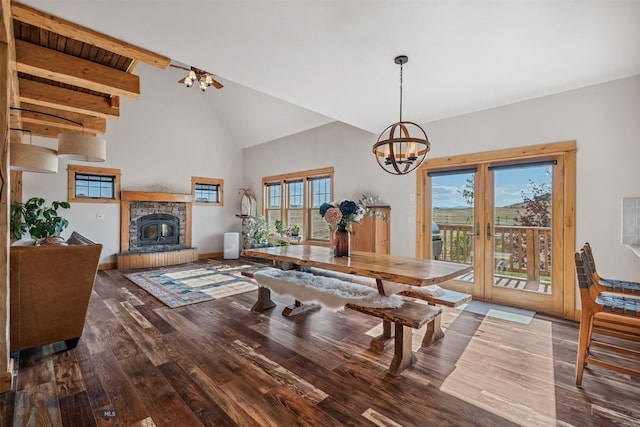 219 Rolling Glen Ranch Loop, Three Forks, MT 59752 - dining space with a chandelier, healthy amount of natural light, wood finished floors, a stone fireplace, and high vaulted ceiling