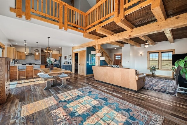 219 Rolling Glen Ranch Loop, Three Forks, MT 59752 - living room with a chandelier, dark wood-type flooring, stairway, beam ceiling, and recessed lighting