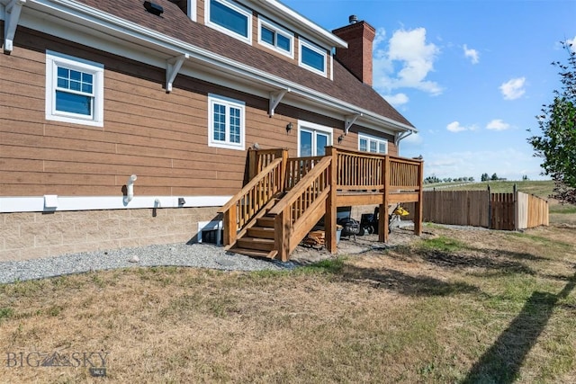 219 Rolling Glen Ranch Loop, Three Forks, MT 59752 - back of property featuring a chimney, stairway, roof with shingles, and a deck