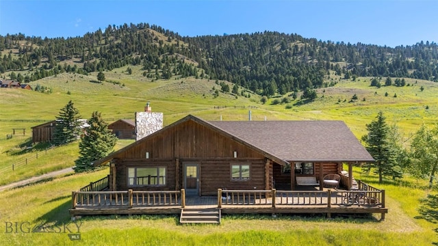 3500 Jackson Creek Rd, Bozeman, MT 59715 - rear view of property featuring log siding, a chimney, and a deck with mountain view