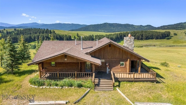 3500 Jackson Creek Rd, Bozeman, MT 59715 - log-style house featuring log siding, a chimney, a front yard, and roof with shingles