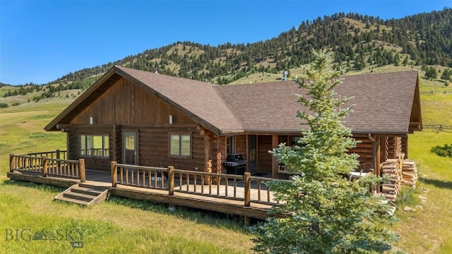 3500 Jackson Creek Rd, Bozeman, MT 59715 - back of property with log siding, a shingled roof, and a deck with mountain view