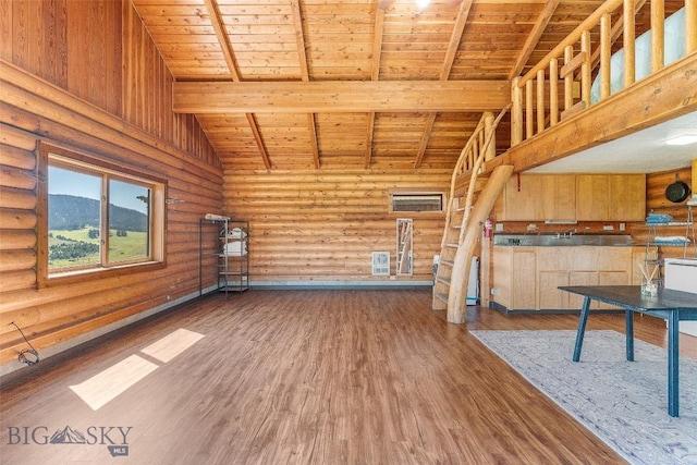 3500 Jackson Creek Rd, Bozeman, MT 59715 - unfurnished living room featuring a wooden ceiling with exposed beams, rustic walls, wood finished floors, and high vaulted ceiling